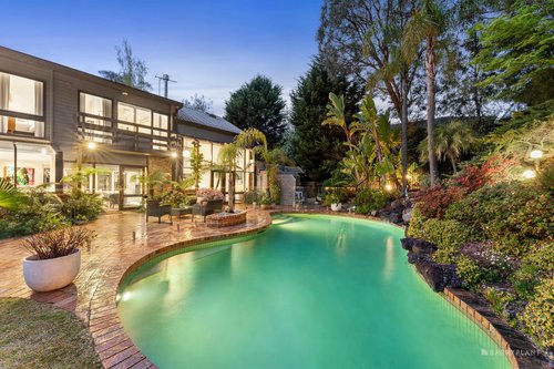 Exterior shot of Park Orchards property showing private oasis with solar heated in-ground pool, spa and cascading water feature take centre stage among spectacular landscaped gardens.